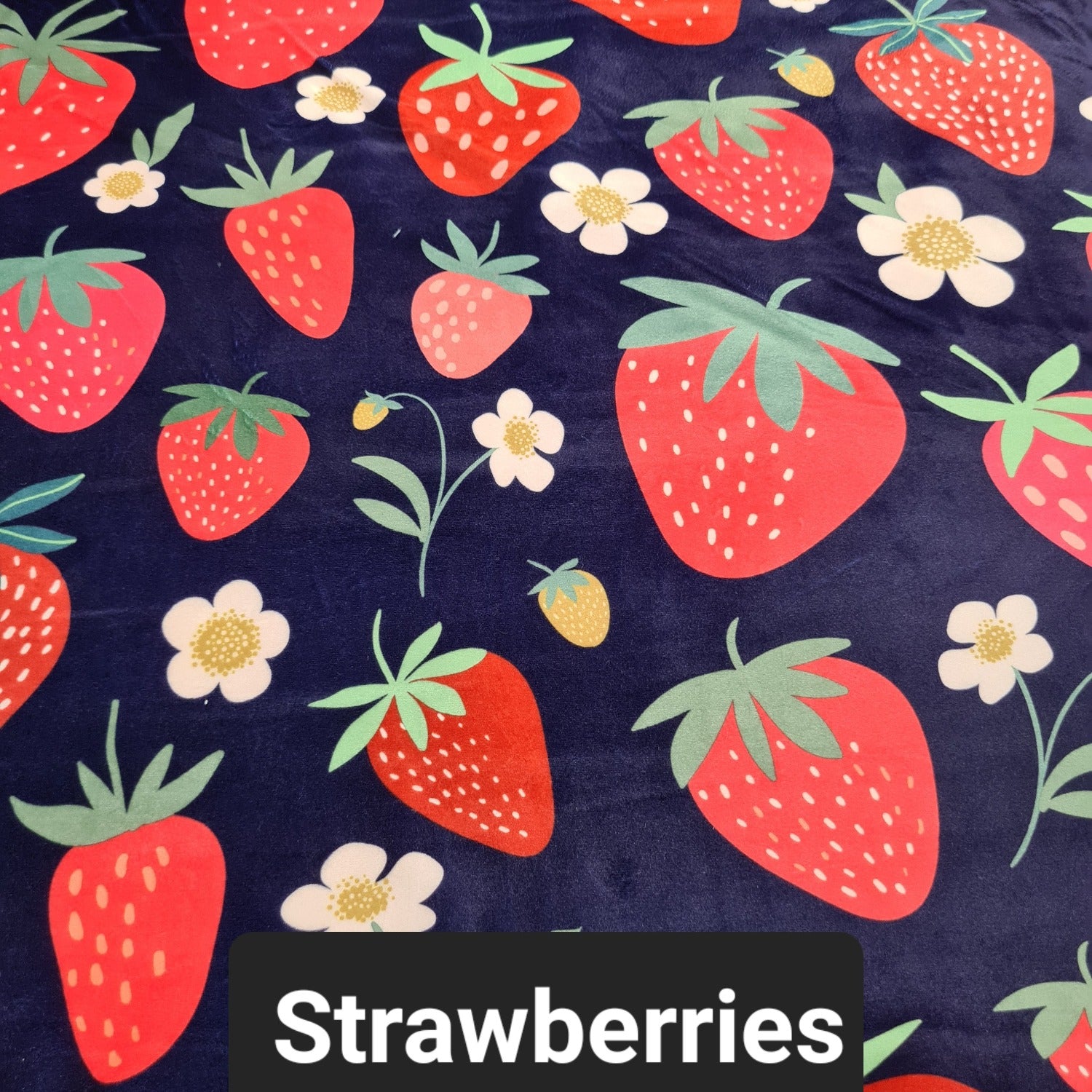 Navy fabric with red strawberries and cream coloured flowers