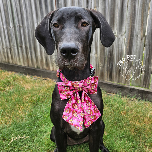 Black great dane puppy with pink collar with a sailor bow and bubble o bill print