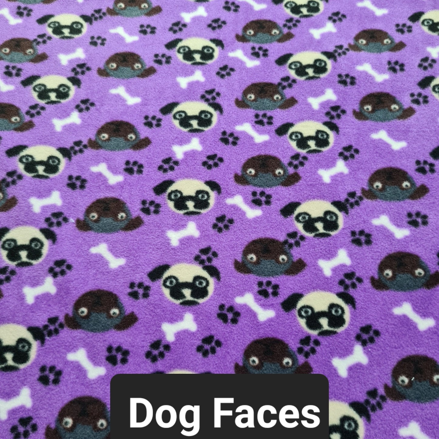 Purple fleece with dog faces in brown and white