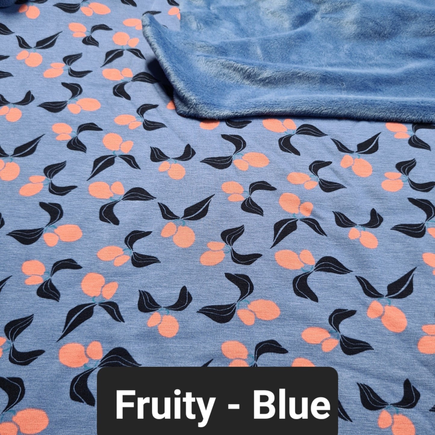 Light blue fleece fabric with orange fruits