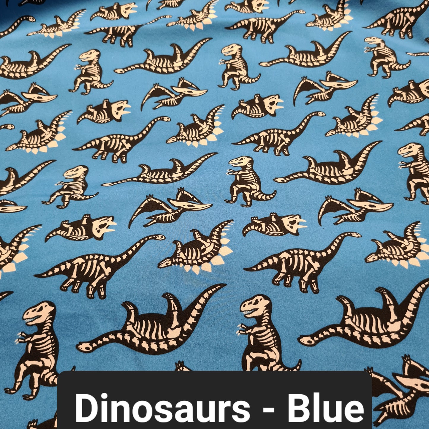 Blue soft shell fabric with dinosaur skeletons