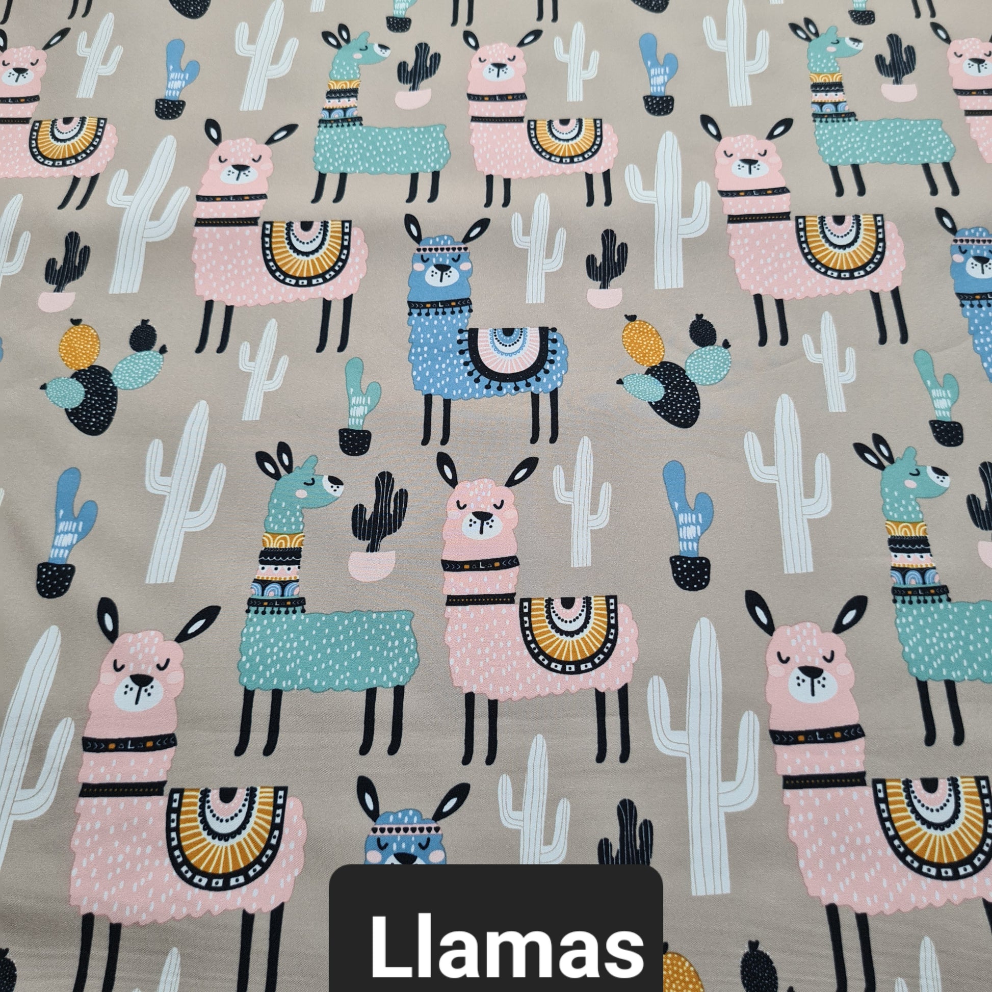 Tan soft shell fabric with pink, green and blue llamas