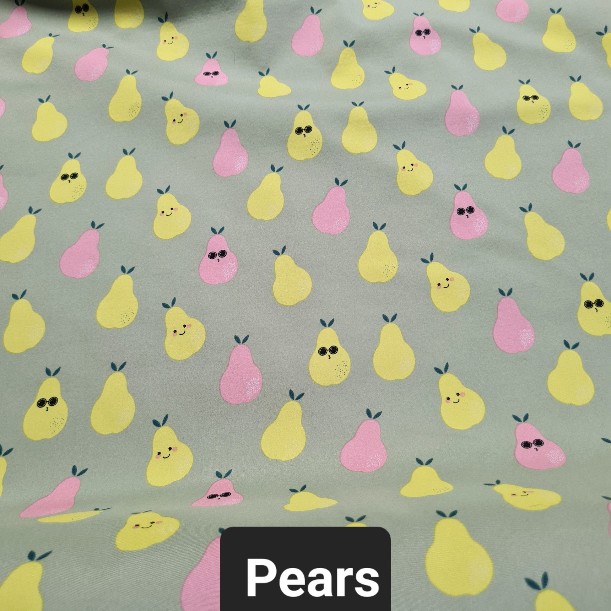 Green soft shell fabric with smiling pears and pears wearing glasses