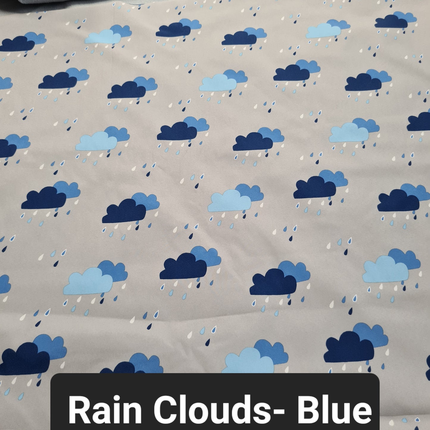 grey soft shell fabric with blue rain clouds and rain