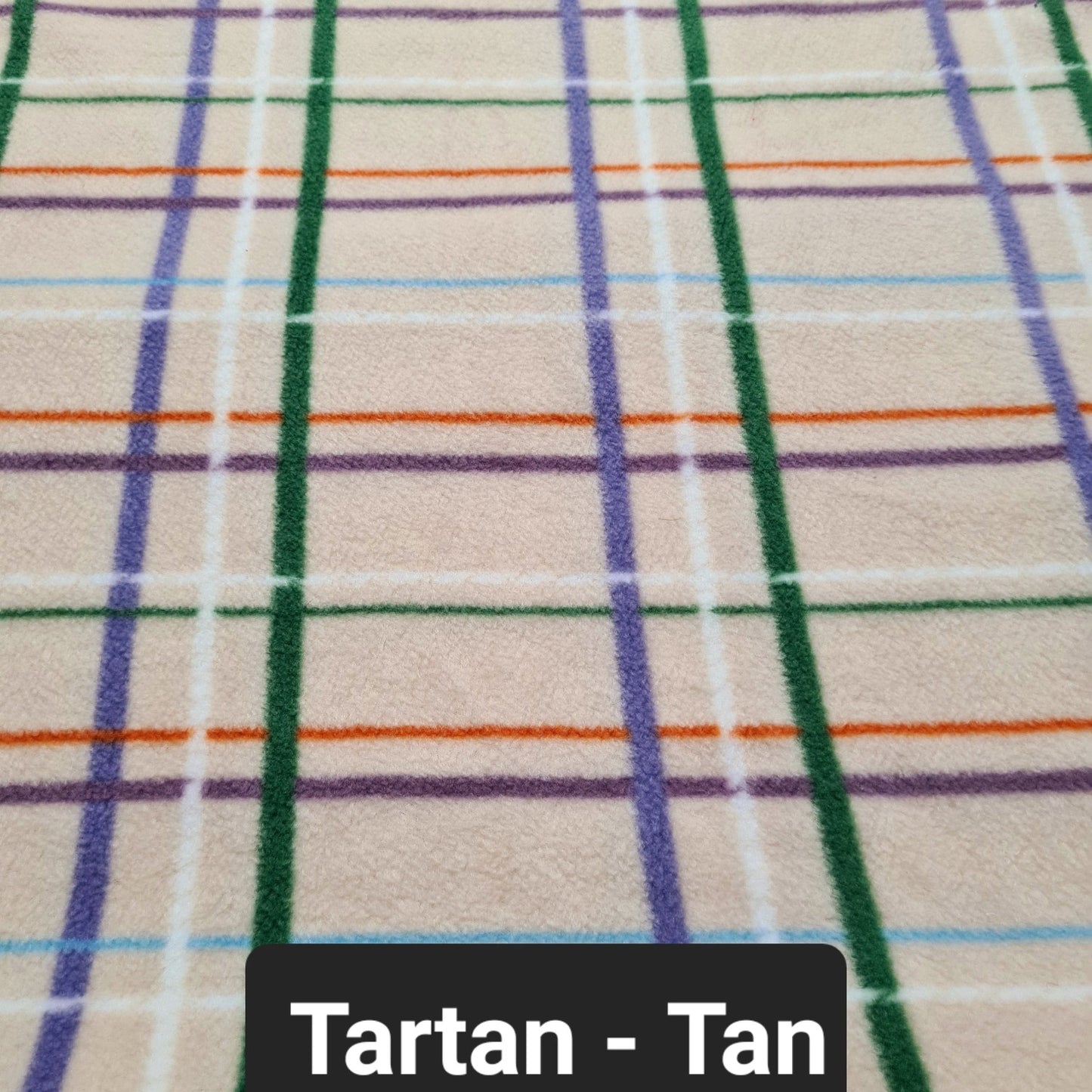 Cream coloured fabric with purple, whit and green checks