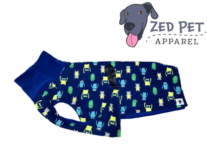 Navy blue dog coat with colourful monsters and a navy turtlenck on the dog coat